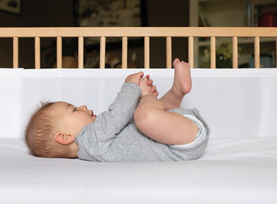 Airwrap Mesh Cot Liner with a baby in the cot