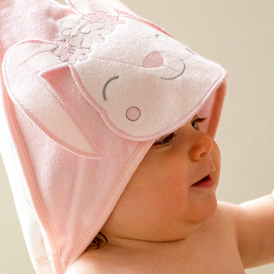 Baby with a pink bunny hooded towel on