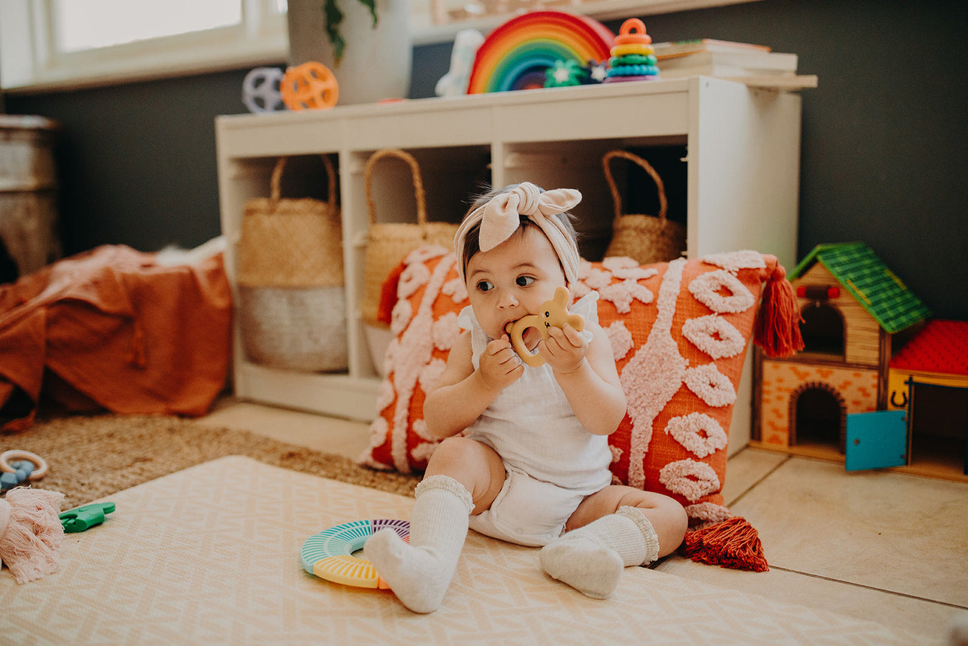 Baby playing with toys in a playroom
