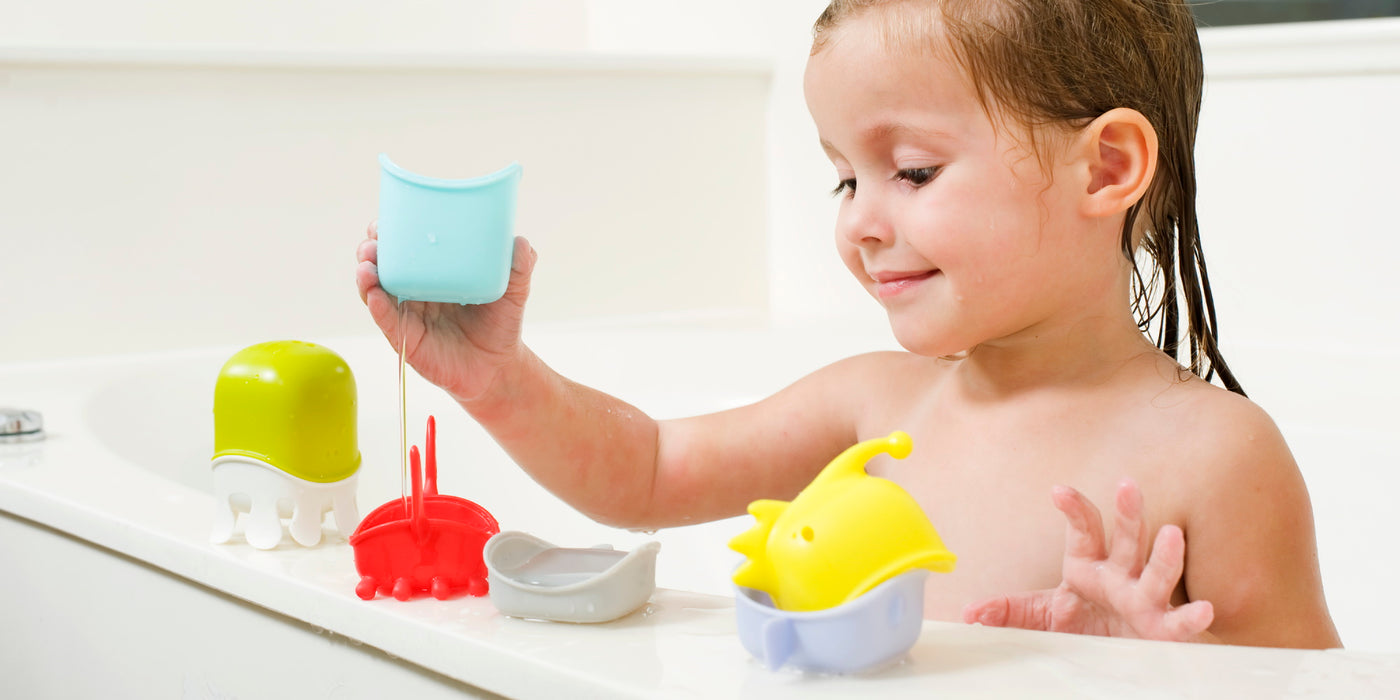 Girl playing with bath toys