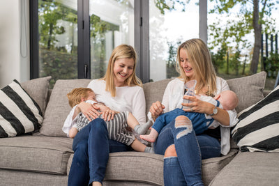 Two mums breastfeeding and bottle feeding their babies