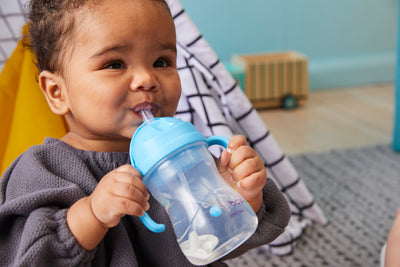 Baby drinking from a training sippy cup
